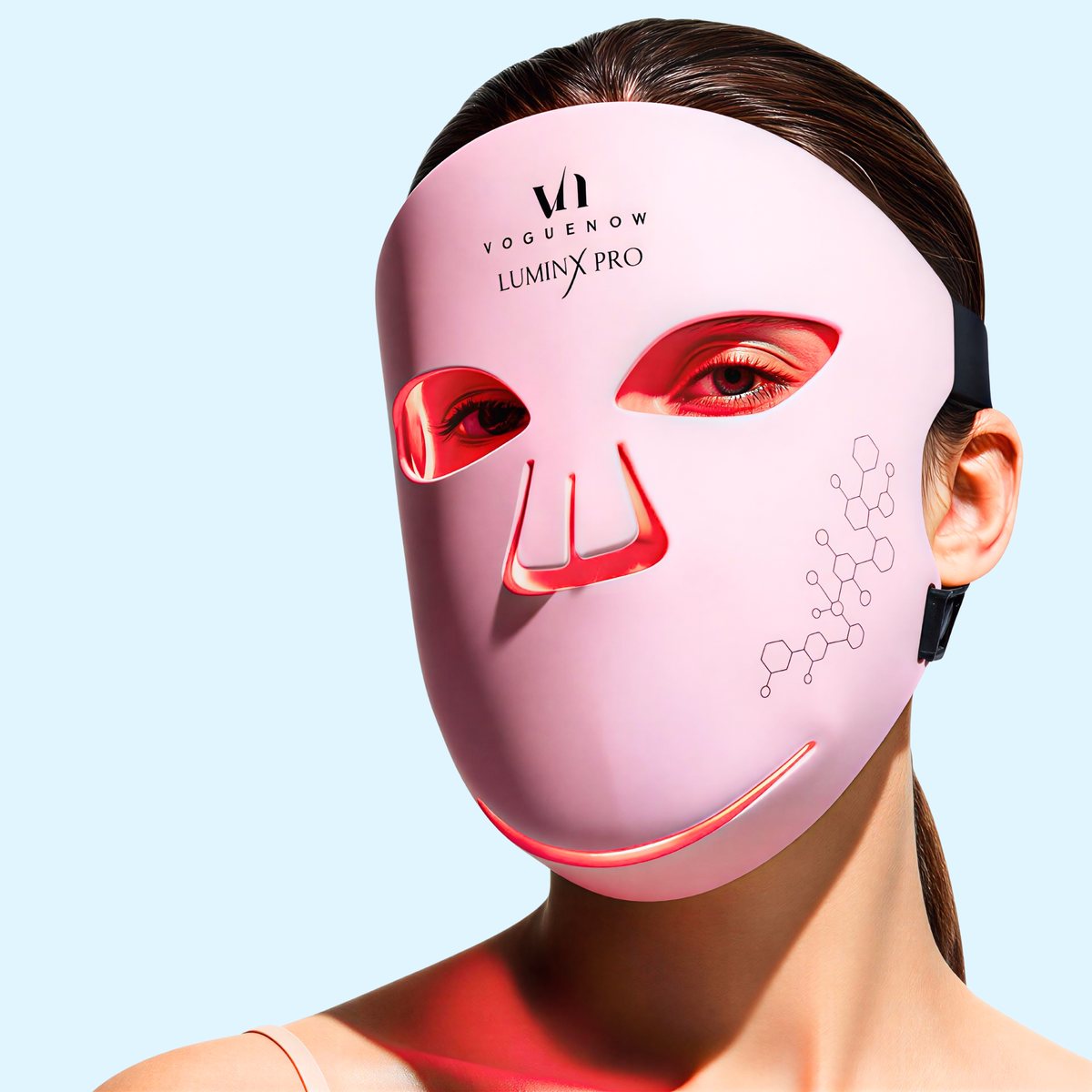 An at-home LED light therapy mask in use, showing red light output around the eye, nose and chin cut-outs